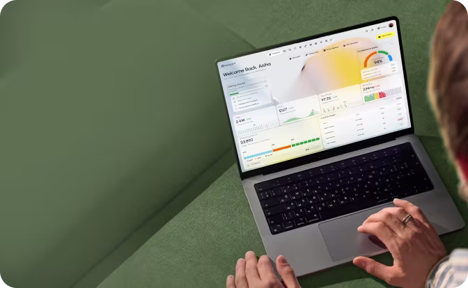 Person viewing an analytics dashboard with charts and data on a laptop screen.